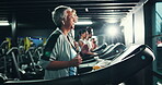 Fitness, music and mature woman on treadmill in gym for cardio training, health or wellness. Earphones, exercise and running with athlete in sports club for challenge, performance or workout