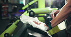 Hands, spray and wipe for exercise equipment in gym, detergent or sanitizer for hygiene. Dirt removal, disinfect and person with bottle for cleaning product, cloth and janitor for fitness club