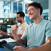 Computer, fist pump and smile of programmer man at desk in office as ...