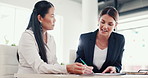 Business women, writing and meeting with documents for legal agreement, contract or partnership at office. Female people, discussion and paperwork with financial advisor for form or application
