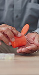 Hands, elderly person and pills on table with medicine, planner for health and treatment for sick patient at home. Pharmaceutical drugs, supplements or antibiotics with daily routine for healthcare