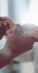 Home, holding hands and couple with care, ring and empathy with compassion, relationship and trust. Closeup, people and jewellery with sympathy, kindness and gratitude with love, support and marriage