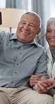 Selfie, laughing and senior couple on sofa holding hands with love, memory and bonding together in home. Digital photography, old man and woman on couch with smile, relax and happiness in marriage