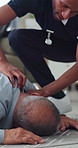 Faint, emergency and nurse in home with old man, checking pulse and medical support. Healthcare crisis, caregiver and senior person on floor from fall, heart attack or stroke with homecare help