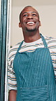 Coffee shop, thinking and man at front door in cafe for friendly service, small business and hospitality. Restaurant, cafe and barista, waiter and server with confidence, smile and happy for career