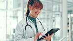 Doctor, woman and typing with tablet in clinic for treatment research, telehealth and online medical advice. Medicine, professional and happy with digital app for healthcare report and shift schedule