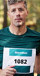 Marathon, face and man with running in forest for fitness challenge, sports event and endurance. Runner, mature person or energy for cardio exercise, competition performance and pace training outdoor