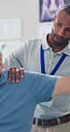 Arm, physiotherapy and doctor with old man in office for rehabilitation, support and muscle injury recovery. Healing, physical therapy and healthcare consulting with senior person in clinic for help
