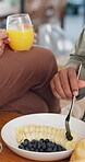 Breakfast, fruit and health with hands of couple in dining room for nutrition, bonding or wellness. Food, love and vitamins with closeup of people eating at home together for brunch and snack