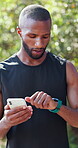 Fitness, black man and phone with smart watch outdoor for data sync, track pace and check progress. Athlete, runner and pair smartphone at park for workout app, performance metrics and monitor speed