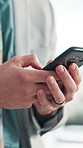Business, hands and man in office, cellphone and connection with internet, social media and network. Closeup, investor or person with smartphone, chatting or digital app for trading and communication