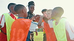 Football field, huddle and coach with children for celebration, motivation and support for sports game. Applause, trainer and kids with hands stack for achievement, soccer goal and confidence boost