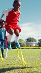 Kids, jump and soccer practice on field for agility training, balance exercise and sports workout. Children, running and equipment for playing game, learning skills and team fitness of match activity