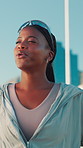 Fitness, tired and black woman breathing in city for sports break, exercise or think of wellness. Rest, fatigue or happy athlete outdoor for cardio recovery, exhausted or runner relax for body health