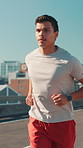 City, man and runner for fitness, wellness challenge and training for marathon on bridge. Outdoor, male person and running with endurance for exercise, cardio and jog in morning on road with workout