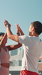 City, people and high five for workout, wellness challenge and training for marathon on bridge. Woman, man and friends running with endurance for exercise, cardio and morning jog on road with fitness