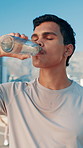 Drinking water, break and man for exercise, training and runner health for cardio or marathon in city. Hydration, athlete and challenge with energy in street for sports fitness, workout and wellness
