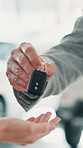 Keys, car and purchase with hands of people at dealership for test drive, auto showroom and vehicle decision. Salesman, automobile and transport choice with closeup of customer for rental agreement