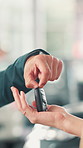 Hands, buyer and salesman with keys at car dealership for vehicle purchase, hiring success and test drive. Showroom, person and deal with driver for automobile collection, rental agreement and offer