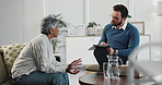 Man, therapist and meeting with mature patient for stress, trauma or counseling at office suite. Male person, client and discussion with counsellor taking notes for health advice, progress or session