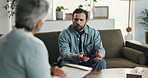 Therapy, talking and man with therapist in office for consulting, advice and emotional support. Psychology, mental health and woman with clipboard for patient for writing notes, counseling or session
