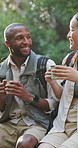 Hiking, talking and friends in nature with drink for outdoor adventure, trekking and fresh air. Travel, exercise and man with woman resting in forest for bonding, relax and conversation on weekend