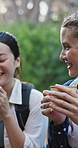 Hiking, friends and women in nature with drink for outdoor adventure, trekking and fresh air. Travel, exercise and people resting with tea in forest for bonding, relax and conversation on weekend