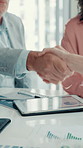 Business people, closeup or shaking hands for financial charts achievement, target or profit growth. Tablet, handshake or clapping in meeting for success, graphs or well done for investment agreement