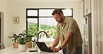 Remote work from home, computer and man in kitchen, website info and email for proposal. Person, copywriting and freelancer with laptop, editing and research for article or feedback for news report