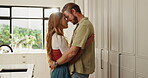 Hug, romantic and couple with dancing in kitchen for bonding together, connection and security. Dancer, people and affection in home with embrace, loyalty and streaming music for marriage anniversary