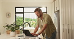Remote work from home, laptop and man in kitchen, website information and email for proposal. Person, copywriting and freelancer with computer, editing and research for article or feedback for report