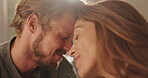 Smile, couple and forehead touch at house for romance, affection and connection of relationship. People, passionate and partner love for special moment, bonding together and commitment of marriage