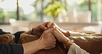 Couple, sofa and holding hands with empathy for trust, commitment or comfort in marriage at home. Closeup, people or support with touch, understanding or safety for sympathy, care or love at house