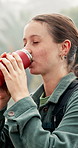 Flusk, hiking and woman with coffee, nature and morning with environment, caffeine and forest. Person, outdoor and hiker in woods, tea or countryside with wellness, health or wilderness with trekking