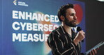 Speaker, man and talk with tablet at conference event for enhanced cybersecurity measurements. Public speaking, presentation and digital for information, data protection and innovation of cyberattack