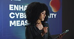 Woman, speaker and tablet at conference event for enhanced cybersecurity measures. Person, public speaking and presentation for online cyberattacks, data protection and innovation for digital safety