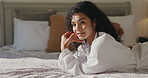 Woman, face or relax with robe on bed for spa day or beauty treatment at luxury hotel. Portrait, female person or lying with smile or satisfaction in bedroom for morning comfort or vacation at resort