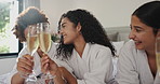 Friends, laughing and cheers with wine at spa for pamper date, celebration and funny gossip. Hotel room, happy women and toast with alcohol on bed for vacation break, hospitality and luxury bonding