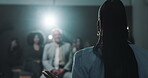 Presentation, public speaking and person with motivation for crowd, politician and speaker on stage. Press conference, legislator and announcement for audience in official event, talking and back