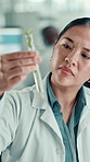 Scientist, woman and plant with test tube in laboratory for botany, medical research and breakthrough. Asian chemist, biotechnology and examine sample for pharmaceutical study or sustainable ecology