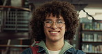 Happy, man and face of student at university for education, learning or studying for exam in library. Smile, confident and portrait of male person with college scholarship for knowledge on campus.