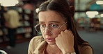 Student, girl or stress with study in library for difficult assignment, exam preparation or deadline. University, gen z person and overwhelmed with reading information, academic pressure and confused