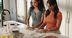 Women, friends and cooking with dough in kitchen for meal prep, homemade pizza and bonding together. Smile, people and baking with ingredients for lunch, culinary skills and dessert process at house