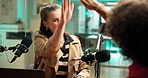 Radio, broadcast and woman with guest, high five or gesture for congratulations in studio or online. Happy, journalist and people with mic for conversation, celebration and chat for media production