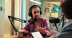 Interview, talk show and woman with mic, radio or journalist with guest in studio or live streaming. Media production, reporter and people with headphones for conversation, streamer and broadcast