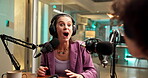 Interview, wow and woman with mic, radio and shocked by guest in studio, journalist or conversation. Media production, reporter and people with headphones for live stream, surprised and broadcast