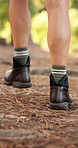 Back, hiking and man with feet, walking and fitness in forest, environment and hobby with boots. Closeup, person and hiker with legs, journey or outdoor with vacation, holiday and wellness with break