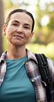 Face, hiking and woman in woods, smile and environment with wellness, holiday and healthy lady. Portrait, mature person and hiker with workout, exercise and vacation with journey, trekking and break