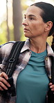 Hiking, walking and woman in forest for thinking, sightseeing and idea for adventure. Trekking, backpacking and person in woods for vacation, travel and exploration with reflection for eco tourism