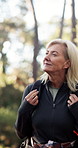 Hiking, walking and senior woman in forest for thinking, sightseeing and travel for adventure. Trekking, backpacking and happy person in woods for vacation, retirement and reflection for eco tourism